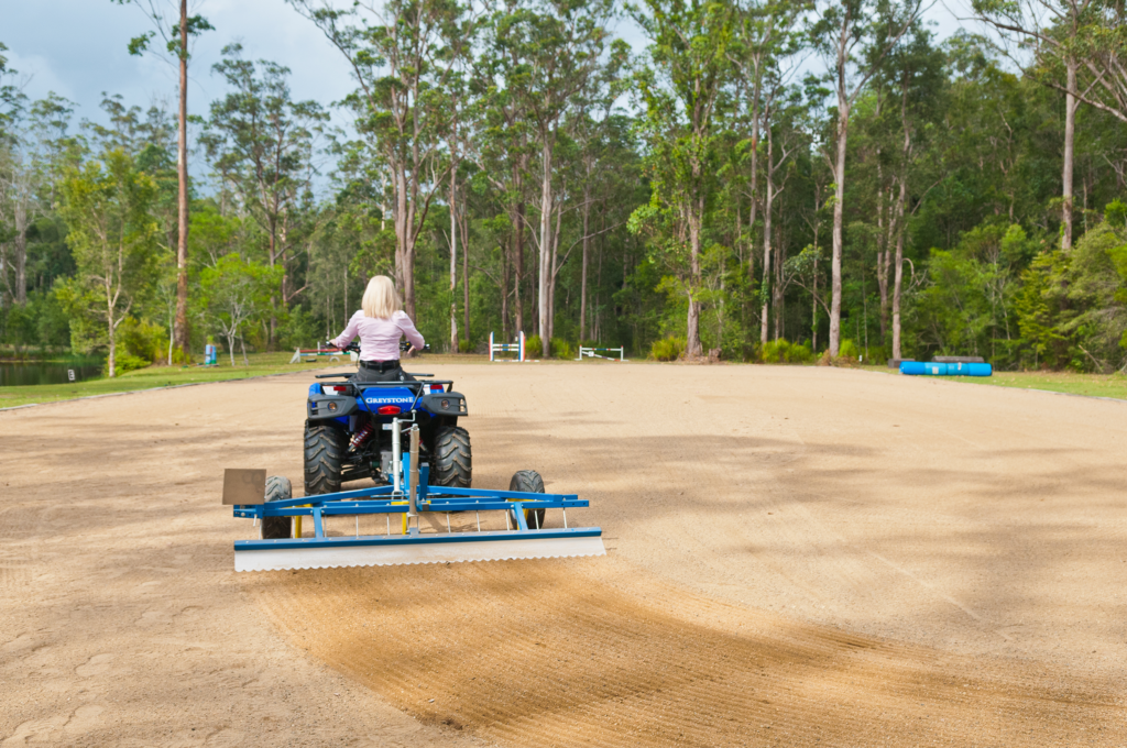 women in a blue ATV with grading