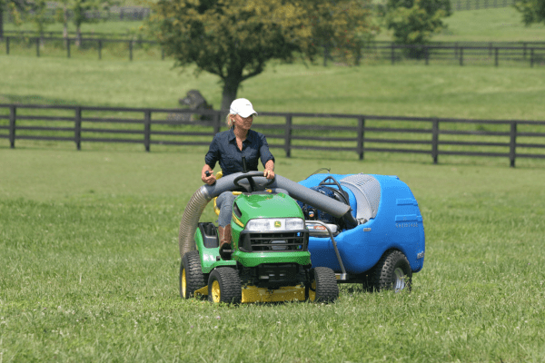 Greystone USA Pasture Vacuums picking up horse manure in a field.