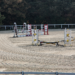 Brown sandy riding arena with obstacles